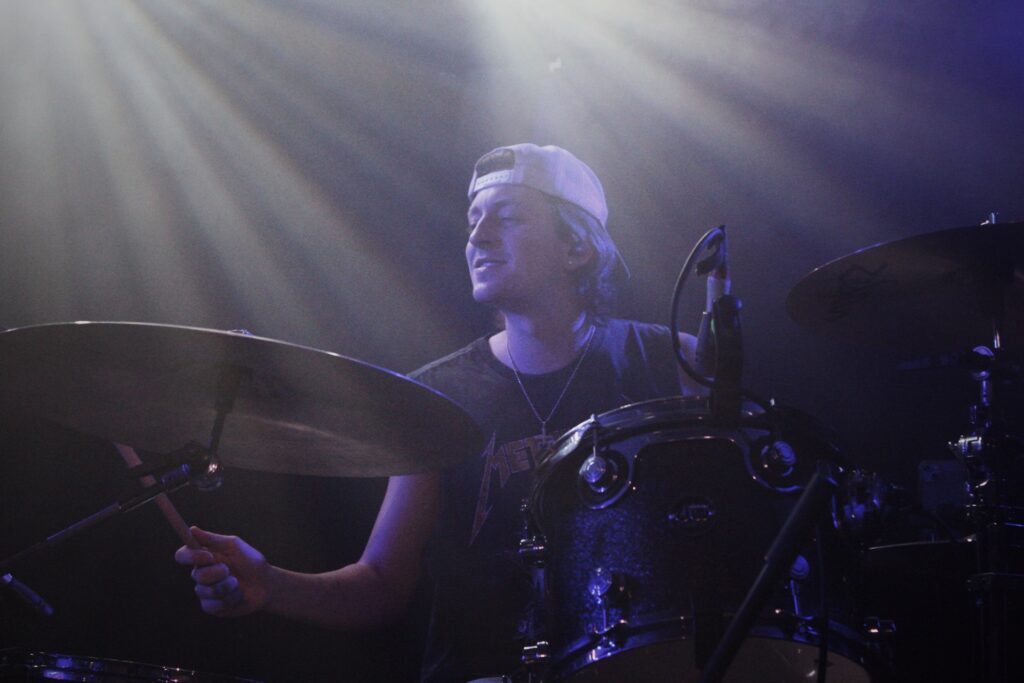 Gus playing the drums at their Manchester show